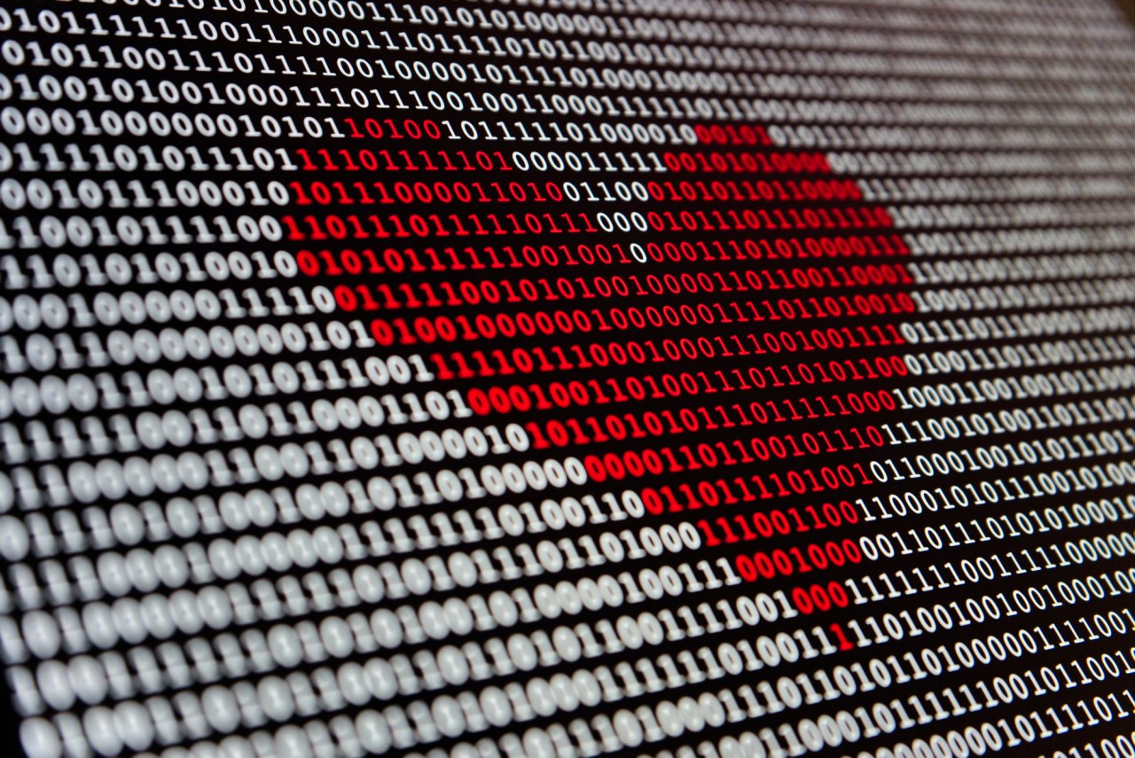 Red heart over binary code.