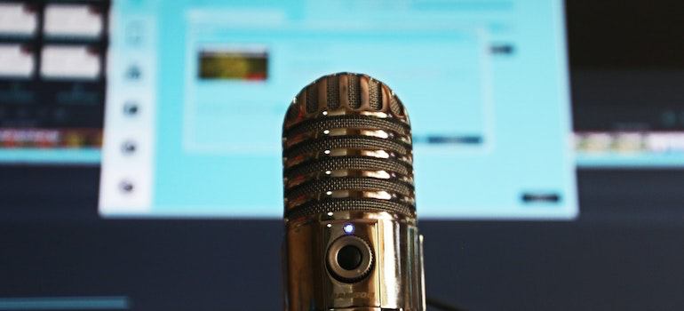 a copper microphone in front of a blue screen